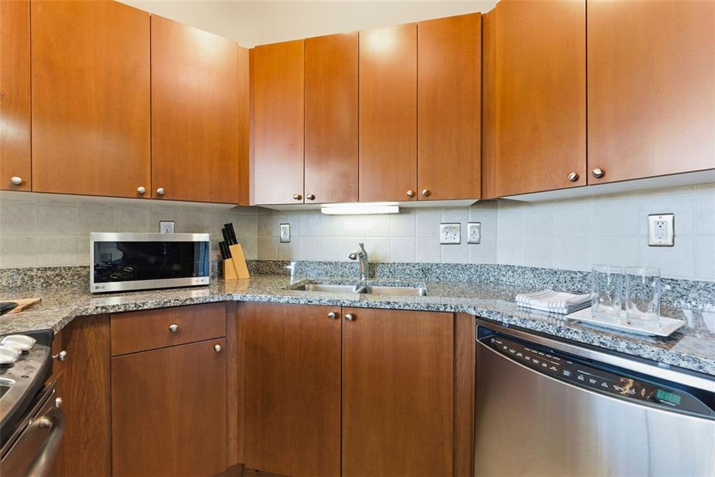 2626 Peachtree Road Northwest, Unit 1006 Atlanta, GA 30305 - Photo 9 of 19 a kitchen with granite countertop a sink a stove and cabinets