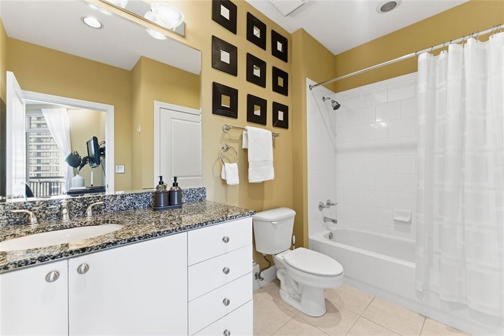2626 Peachtree Road Northwest, Unit 1006 Atlanta, GA 30305 - Photo 10 of 19 a bathroom with a granite countertop sink toilet and shower