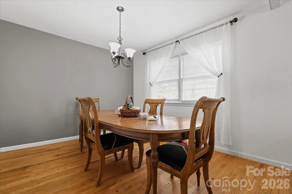 a view of a dining room with furniture wooden floor and a chandelier