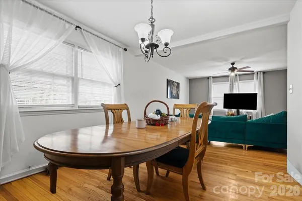a view of a dining room with furniture and a window