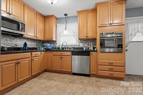 a kitchen with cabinets stainless steel appliances and a sink