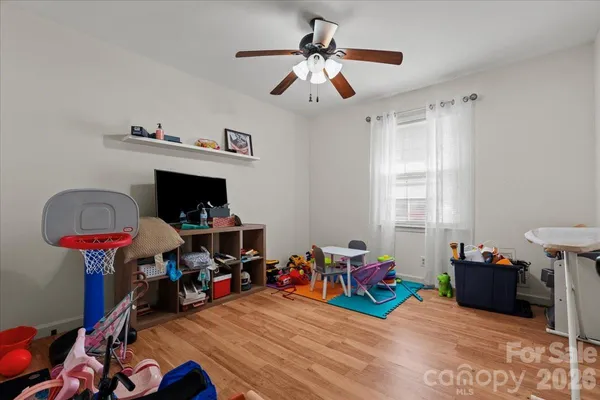 a view of a room with toys and a chandelier