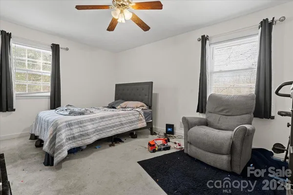 a bedroom with furniture and a window