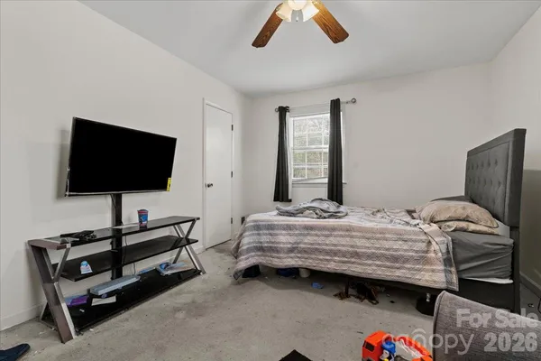 a bedroom with bed and a flat screen tv