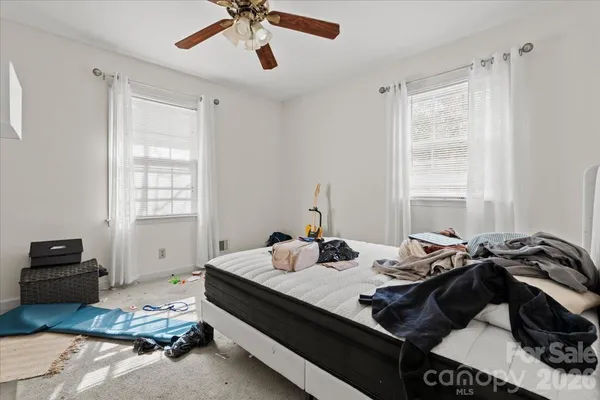 a bedroom with a bed and a window