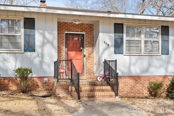 a front view of a house with a garden
