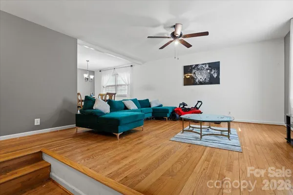a living room with dining room and wooden floor