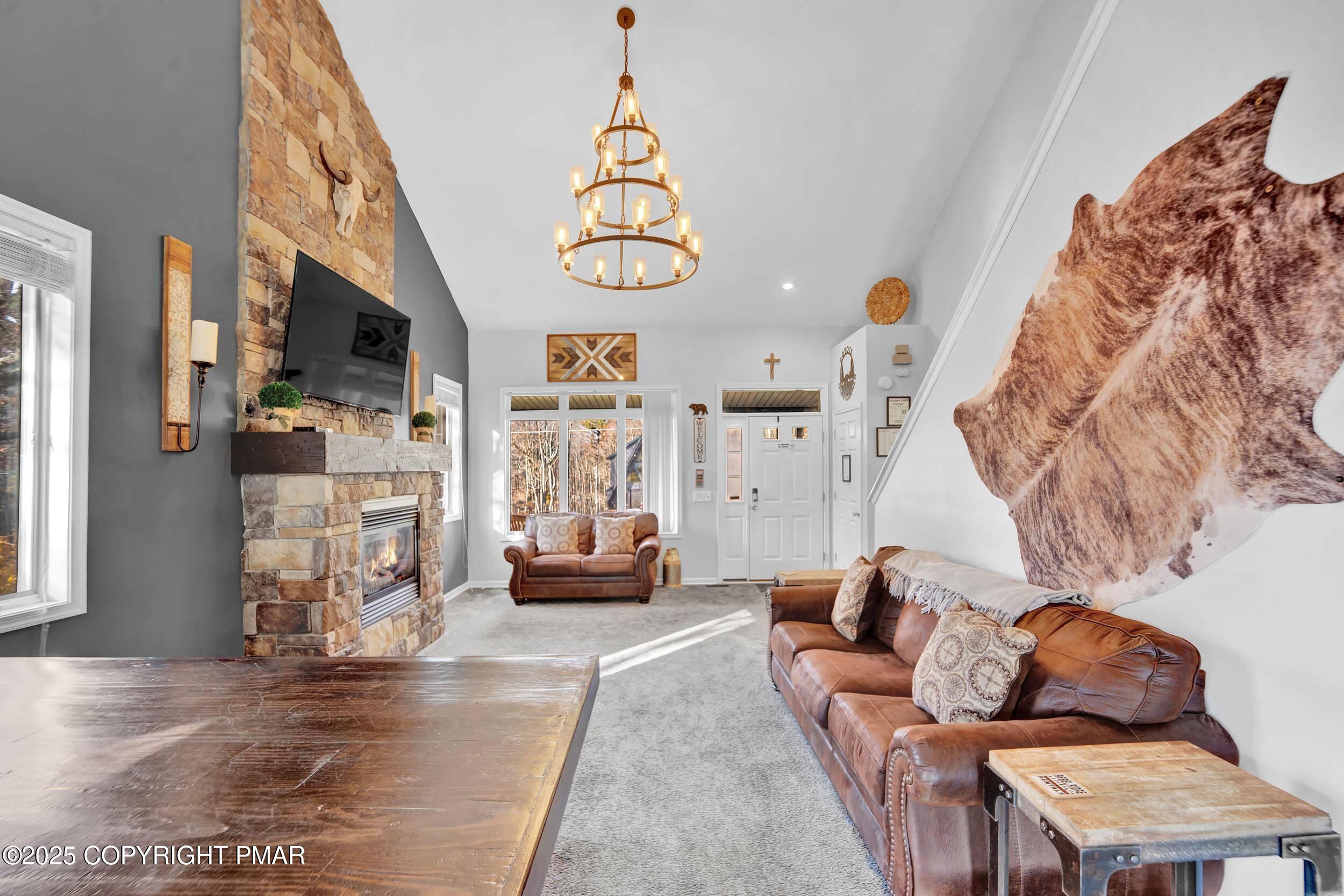 112 Maccauley Road Albrightsville, PA 18210 - Photo 16 of 76 a living room with furniture stairs and a chandelier