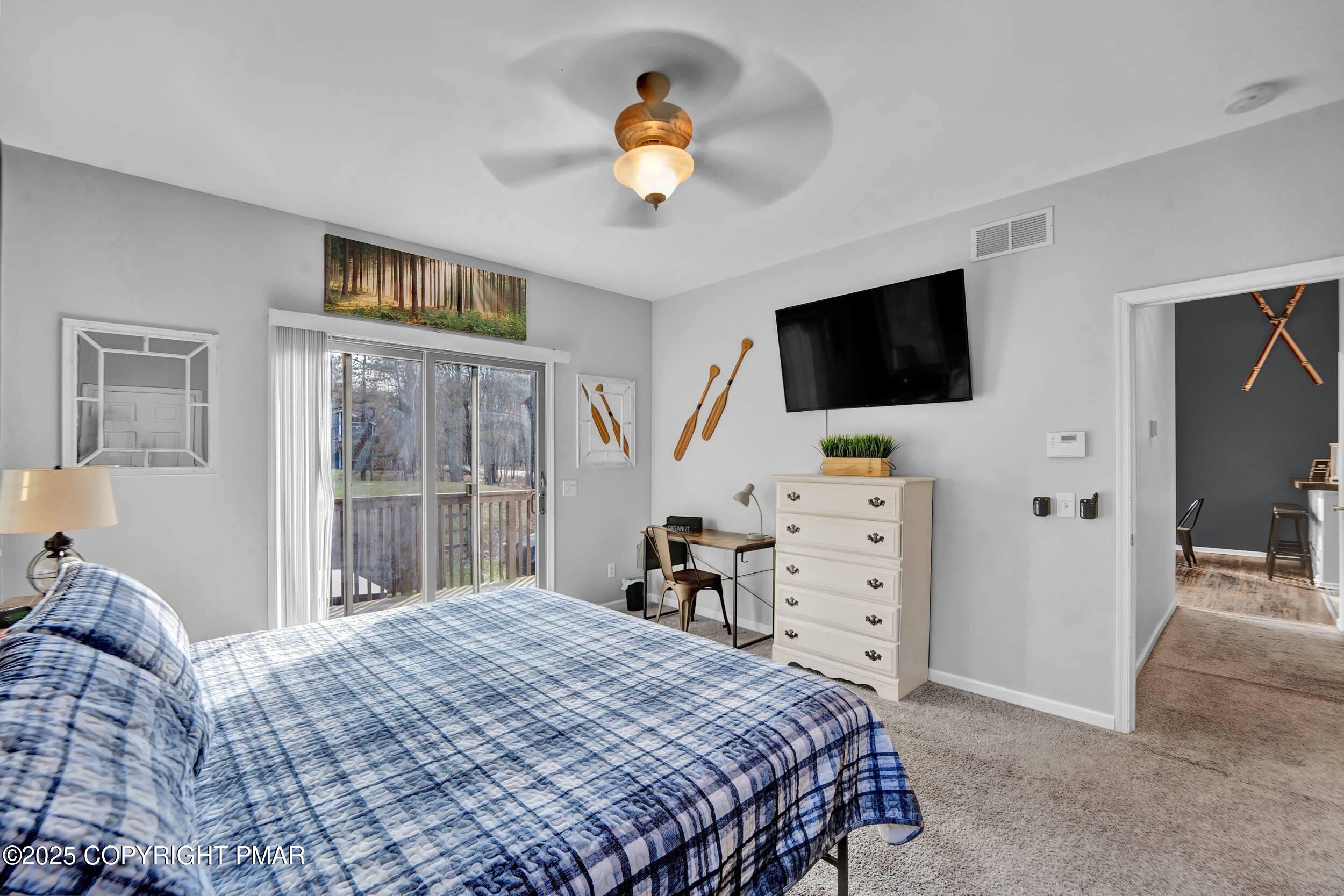 112 Maccauley Road Albrightsville, PA 18210 - Photo 20 of 76 a bedroom with a bed and a flat tv screen on the dresser