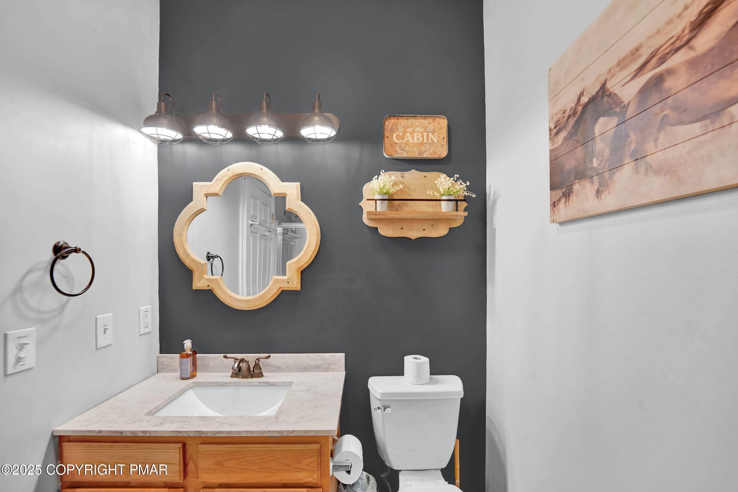 112 Maccauley Road Albrightsville, PA 18210 - Photo 21 of 76 a bathroom with a toilet sink and mirror