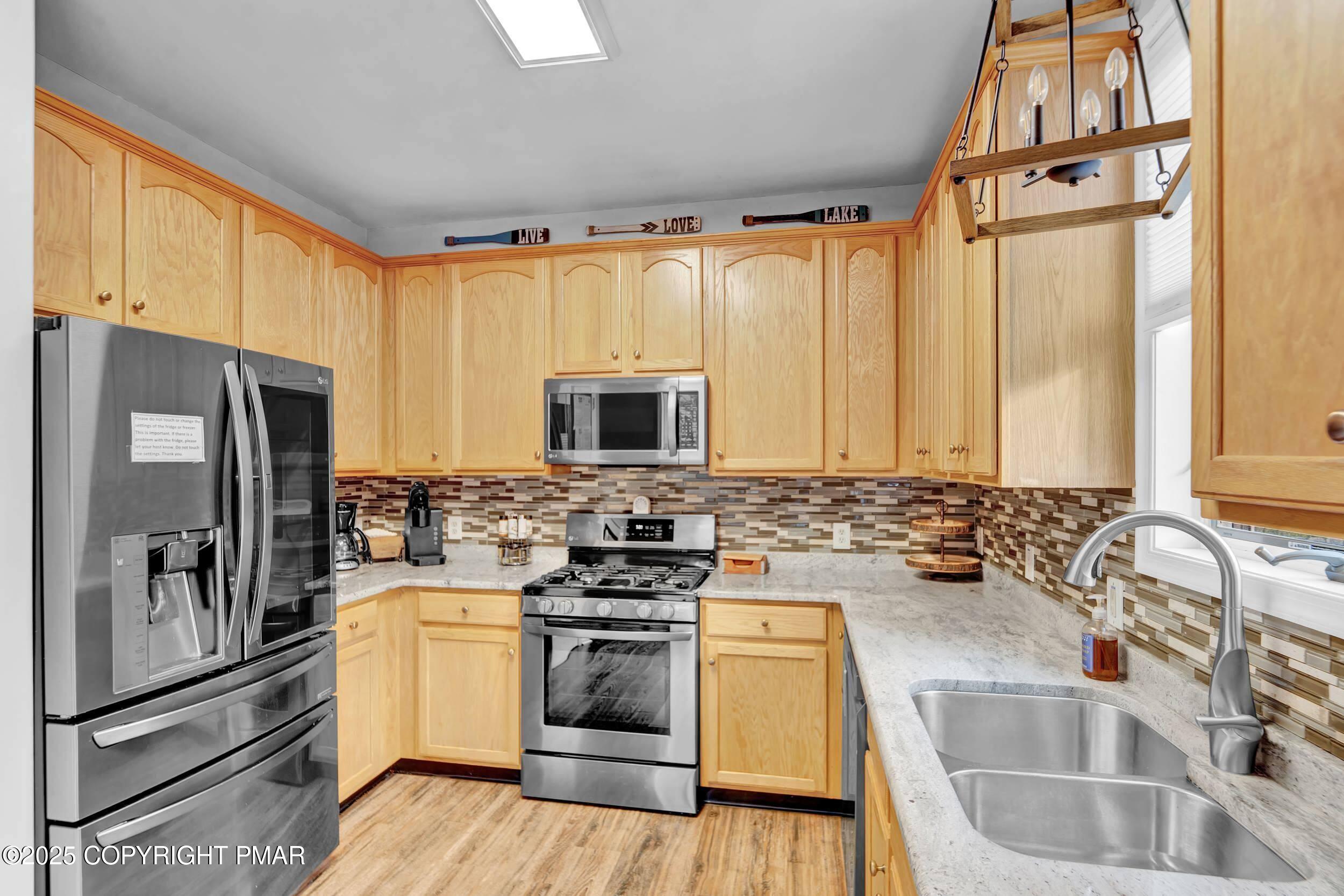 112 Maccauley Road Albrightsville, PA 18210 - Photo 3 of 76 a kitchen with a sink stove and refrigerator