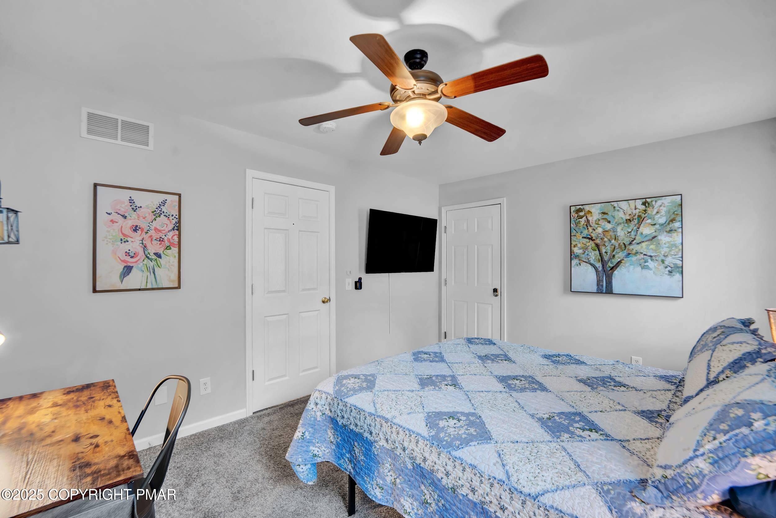 112 Maccauley Road Albrightsville, PA 18210 - Photo 44 of 76 a bedroom with a large bed and a flat screen tv