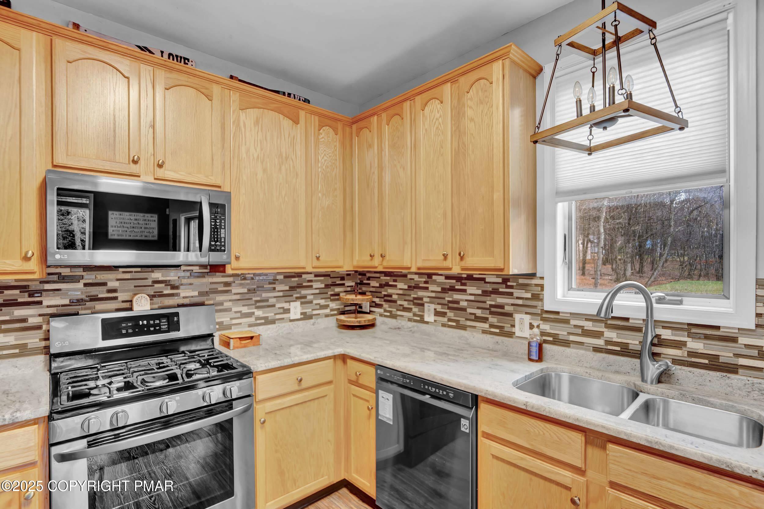 112 Maccauley Road Albrightsville, PA 18210 - Photo 7 of 76 a kitchen with stainless steel appliances a stove a sink and a microwave