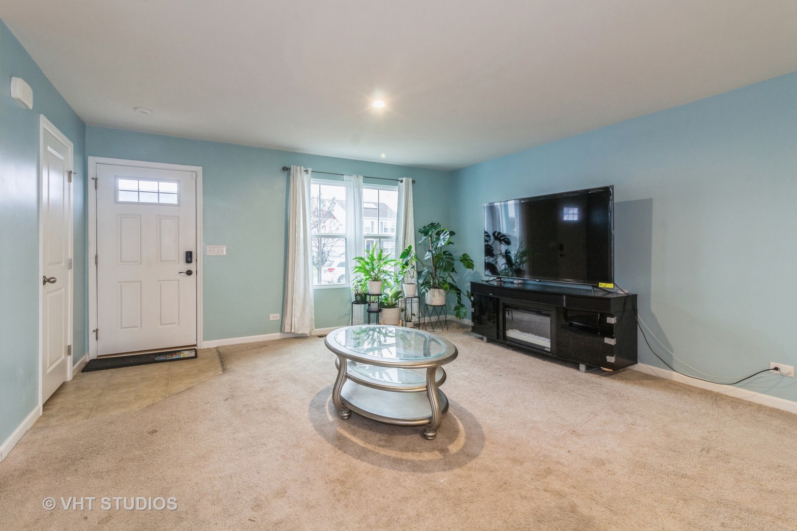 313 Pheasant Run Road Joliet, IL 60433 - Photo 4 of 24 a living room with furniture and a flat screen tv