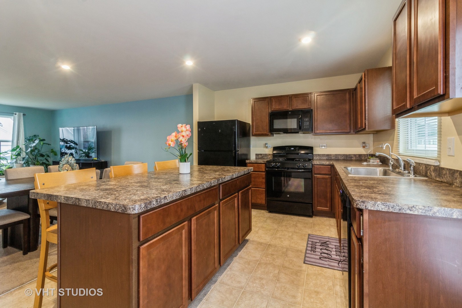 313 Pheasant Run Road Joliet, IL 60433 - Photo 8 of 24 a kitchen with granite countertop stainless steel appliances and wooden cabinets