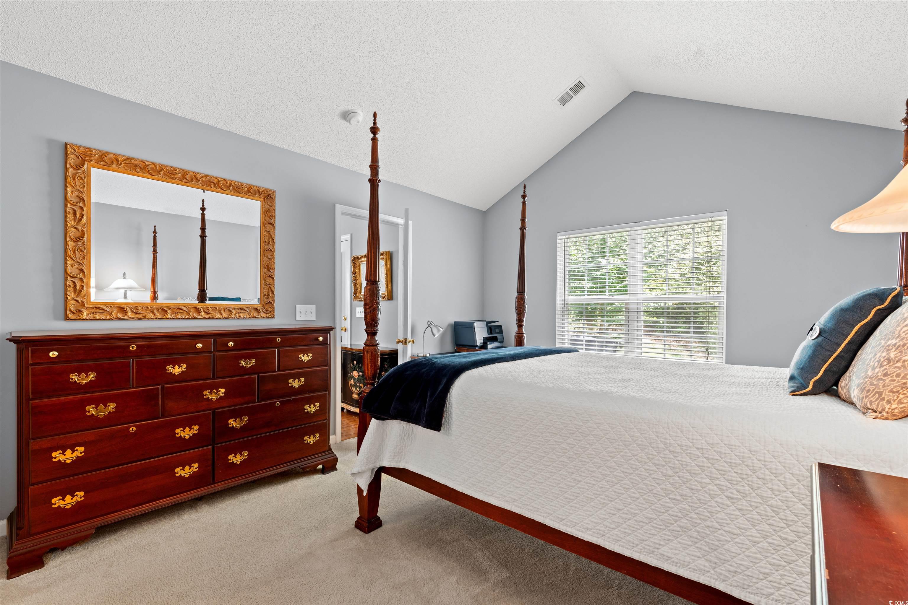 168 Wimbledon Way, Unit 168 Murrells Inlet, SC 29576 - Photo 12 of 27 Bedroom featuring light carpet, a textured ceiling, and vaulted ceiling