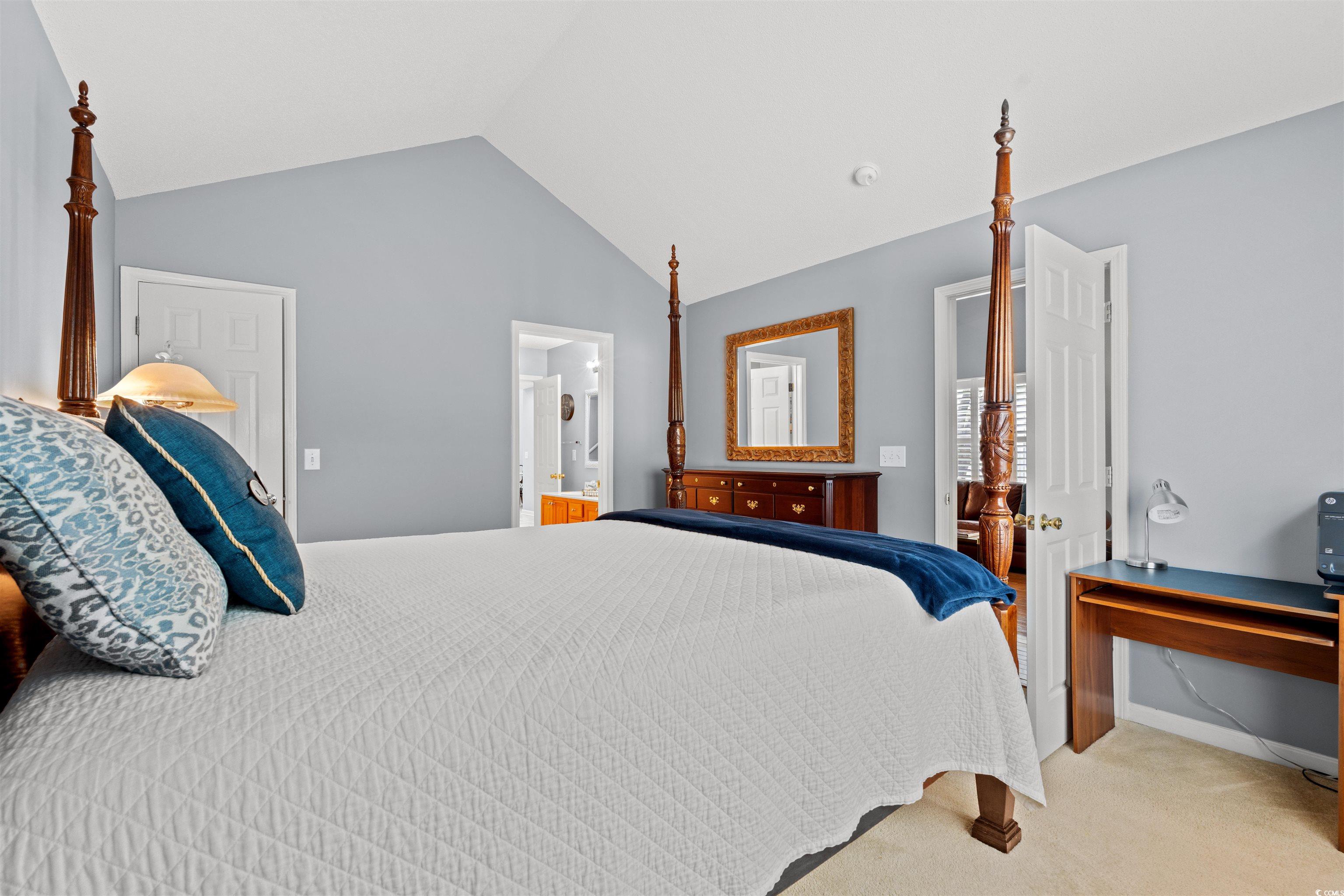 168 Wimbledon Way, Unit 168 Murrells Inlet, SC 29576 - Photo 13 of 27 Bedroom featuring carpet flooring, vaulted ceiling, and ensuite bath