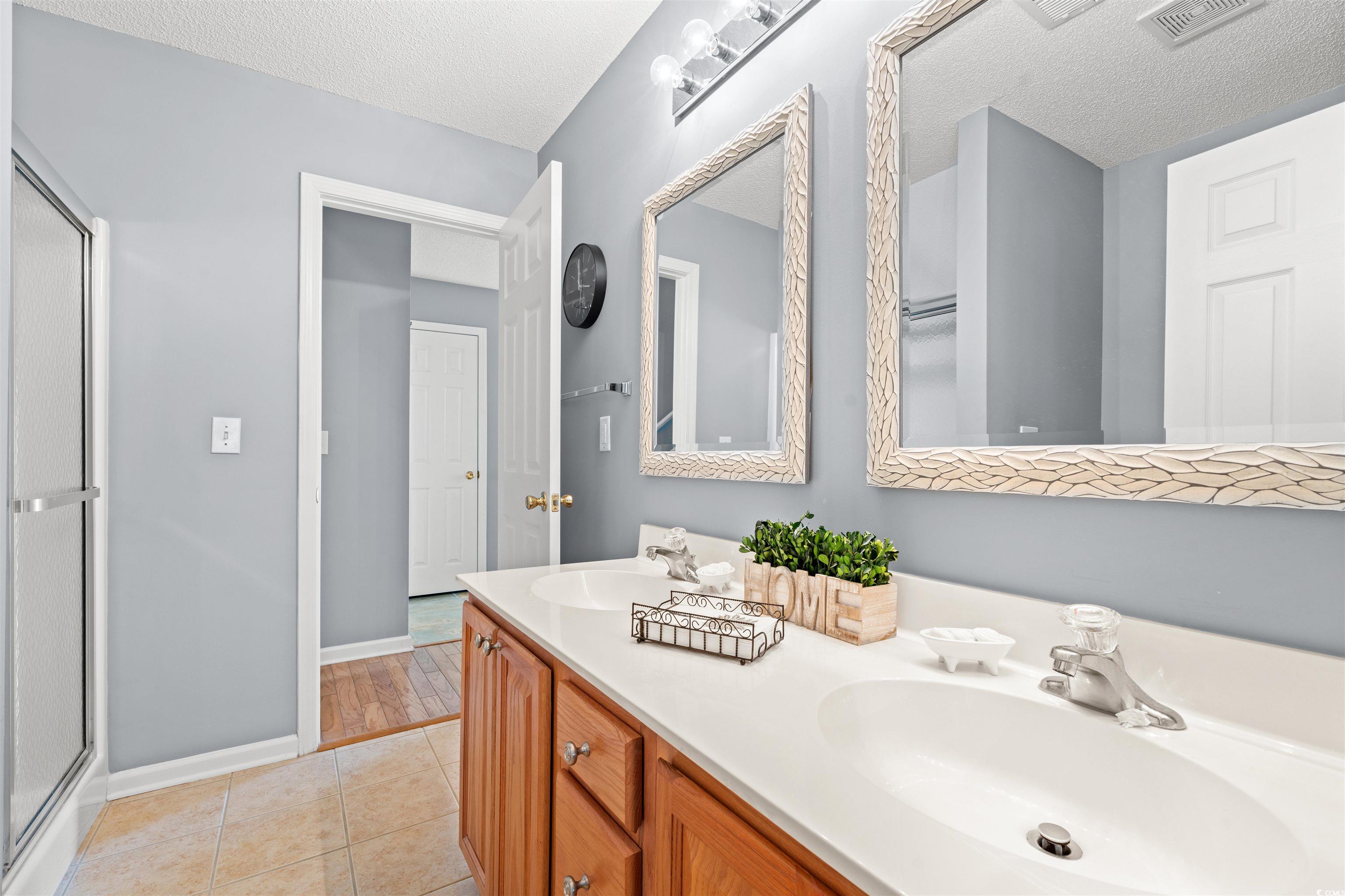 168 Wimbledon Way, Unit 168 Murrells Inlet, SC 29576 - Photo 15 of 27 Full bathroom with light tile patterned floors, a textured ceiling, and a stall shower