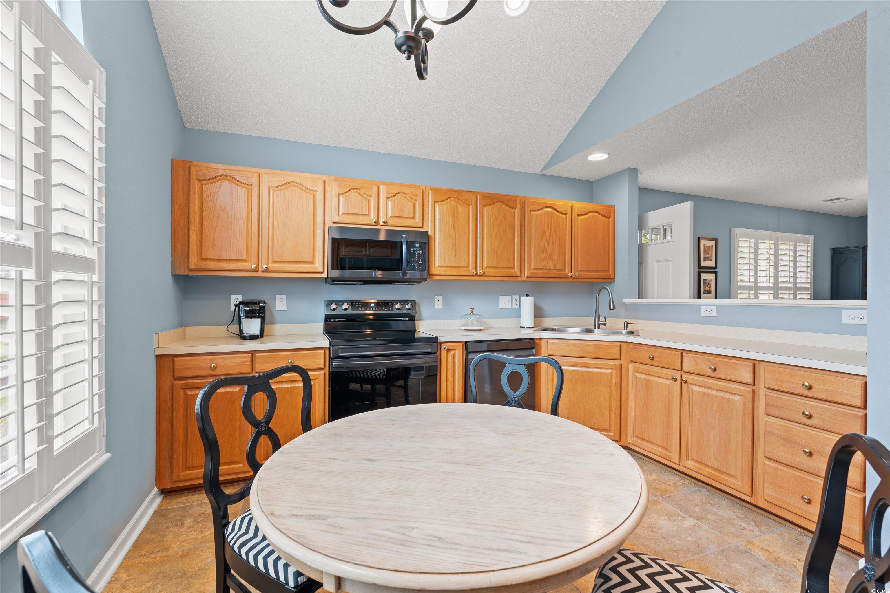 168 Wimbledon Way, Unit 168 Murrells Inlet, SC 29576 - Photo 9 of 27 Kitchen with stainless steel appliances, vaulted ceiling, light countertops, recessed lighting, and light tile patterned floors