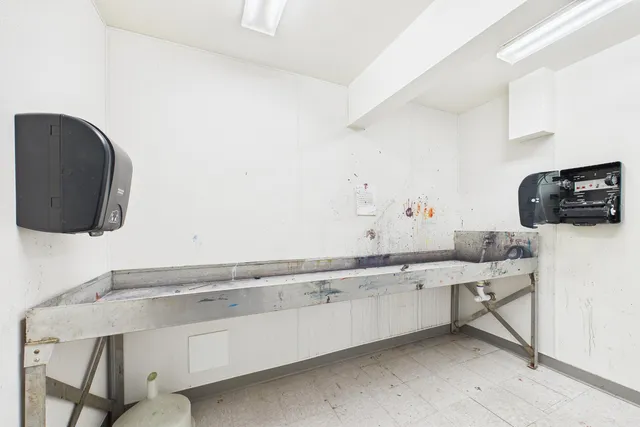 a bathroom with a glass shower door and a shower