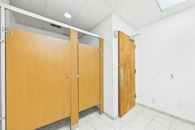 an empty room with a ceiling fan and a window