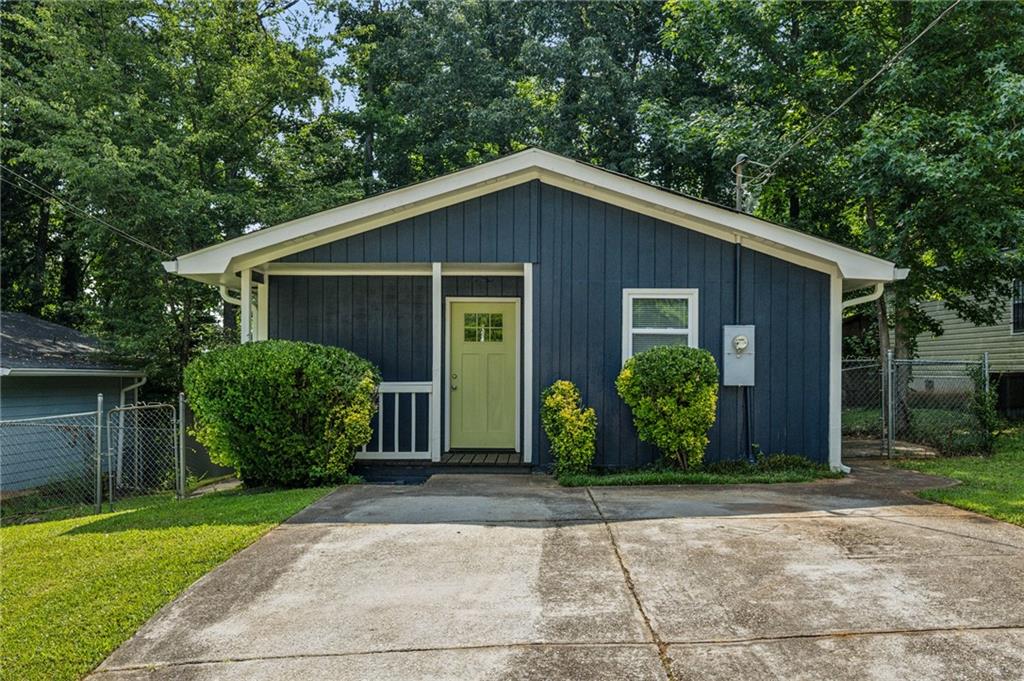 1696 Thomas Street Decatur, GA 30032 - Photo 1 of 1 a front view of a house with garden