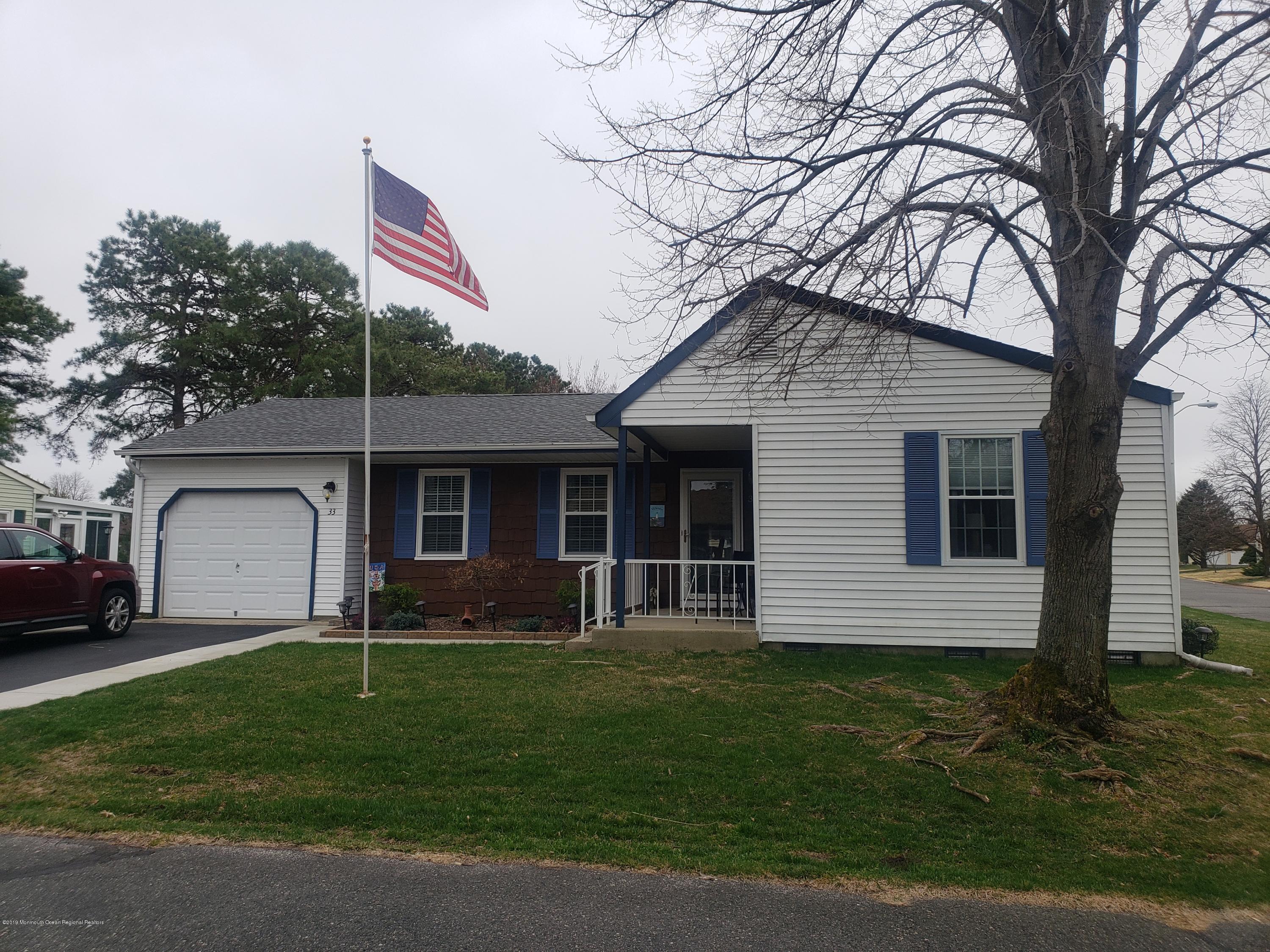 33 Mill Road, Unit 64 Whiting, NJ 08759 - Photo 1 of 23 a front view of a house with a garden and yard