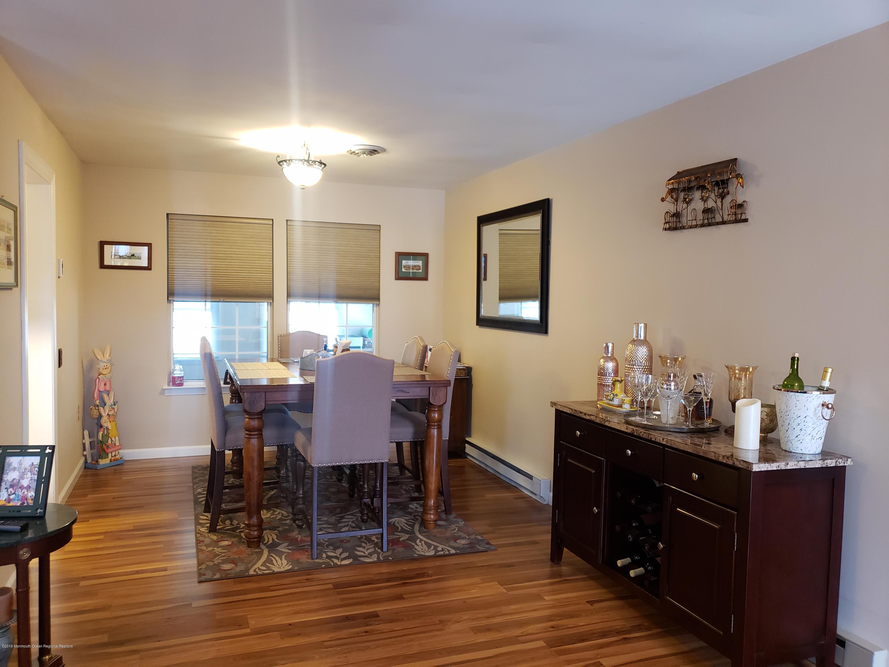 33 Mill Road, Unit 64 Whiting, NJ 08759 - Photo 15 of 23 a view of a dining room with furniture and wooden floor
