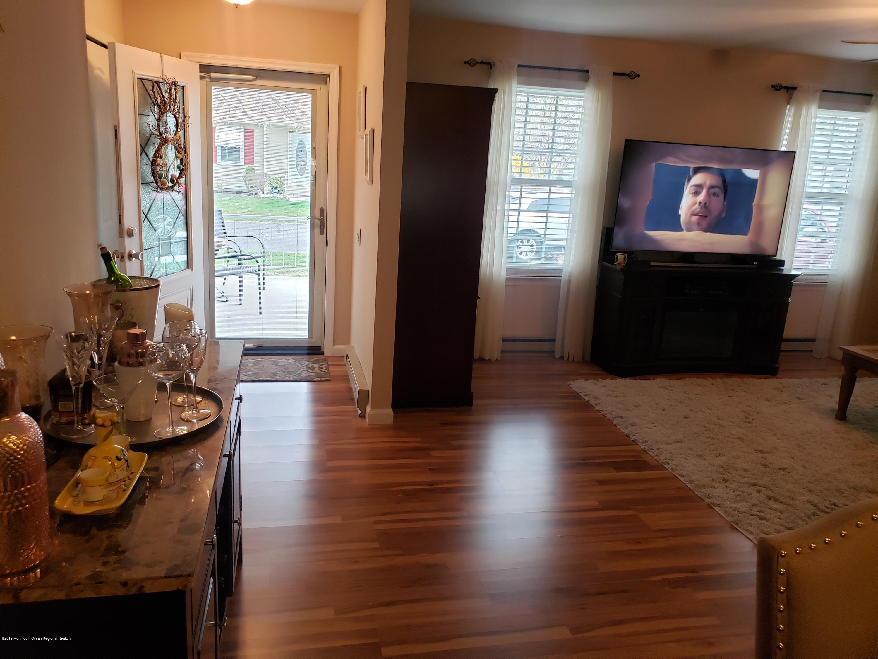 33 Mill Road, Unit 64 Whiting, NJ 08759 - Photo 4 of 23 a living room with furniture and a flat screen tv