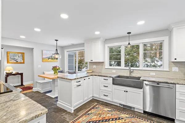 a kitchen with stainless steel appliances kitchen island granite countertop a sink and cabinets