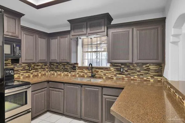 a kitchen with sink cabinets and window