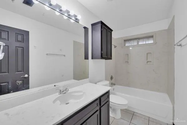 a bathroom with a sink a toilet a mirror and shower