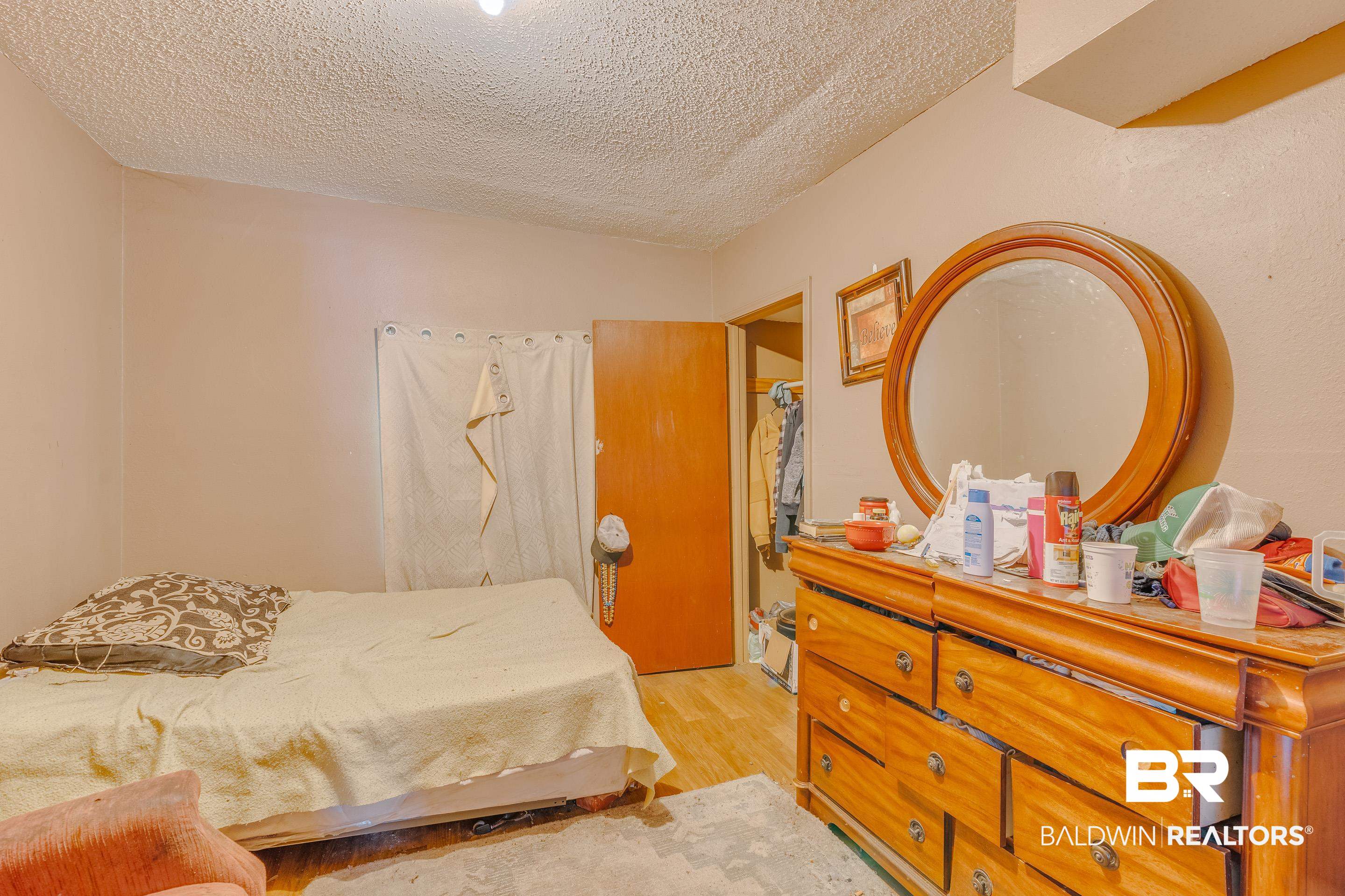 1156 Freeman Street Mobile, AL 36605 - Photo 14 of 22 Bedroom featuring light wood finished floors and a textured ceiling
