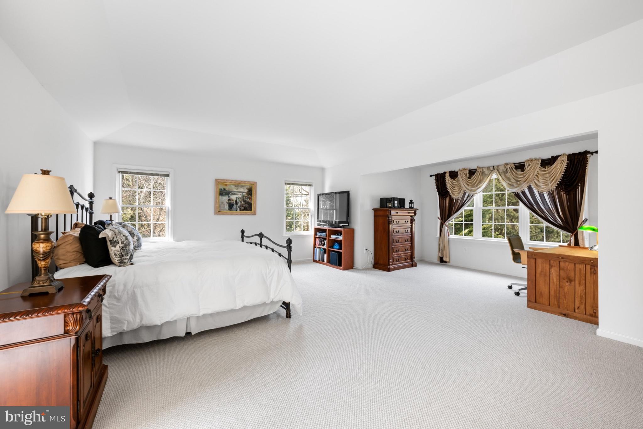 9420 Crimson Leaf Terrace Potomac, MD 20854 - Photo 15 of 33 a bedroom with a large bed and a flat tv screen on dresser