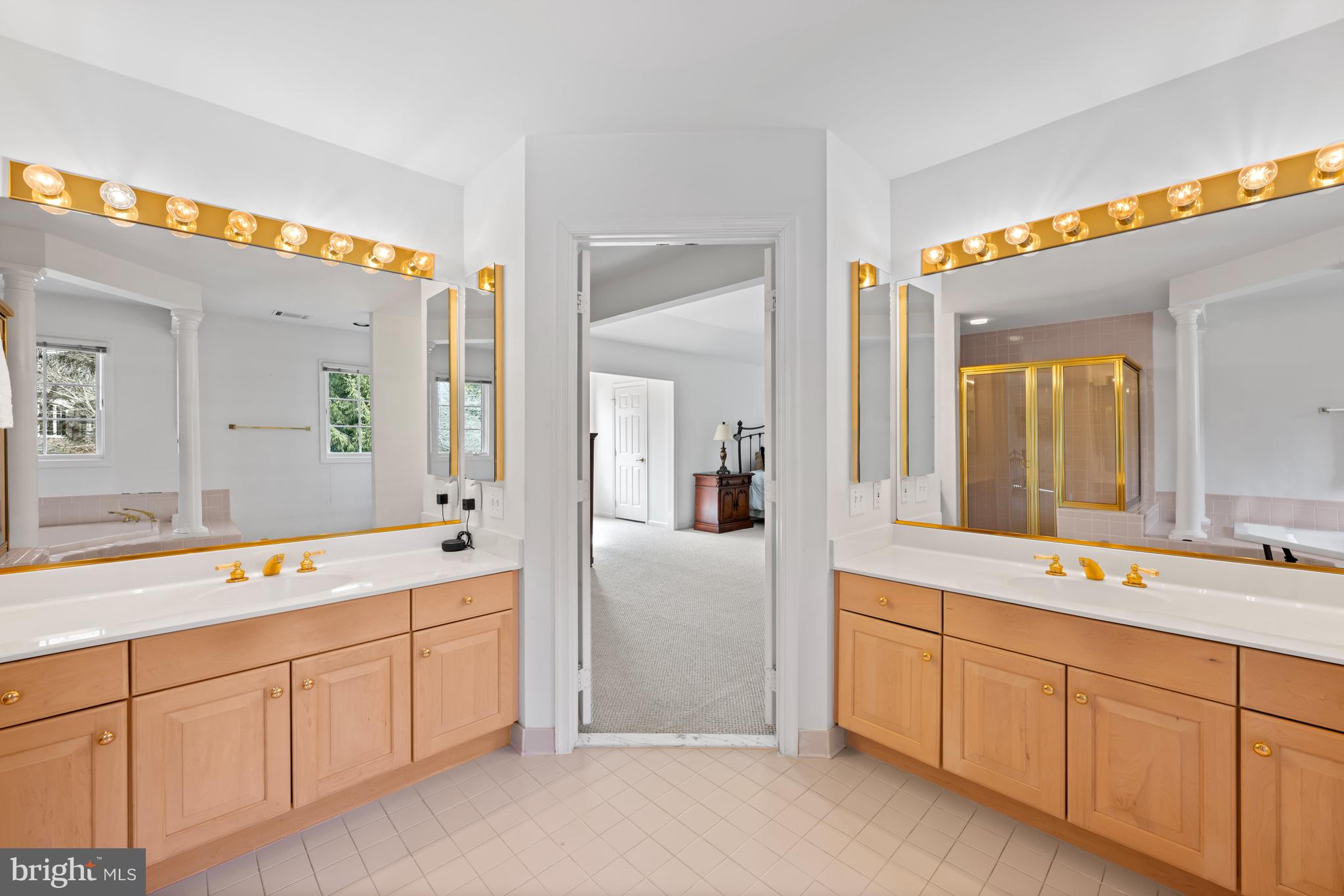 9420 Crimson Leaf Terrace Potomac, MD 20854 - Photo 16 of 33 a spacious bathroom with a granite countertop sink mirror and bathtub