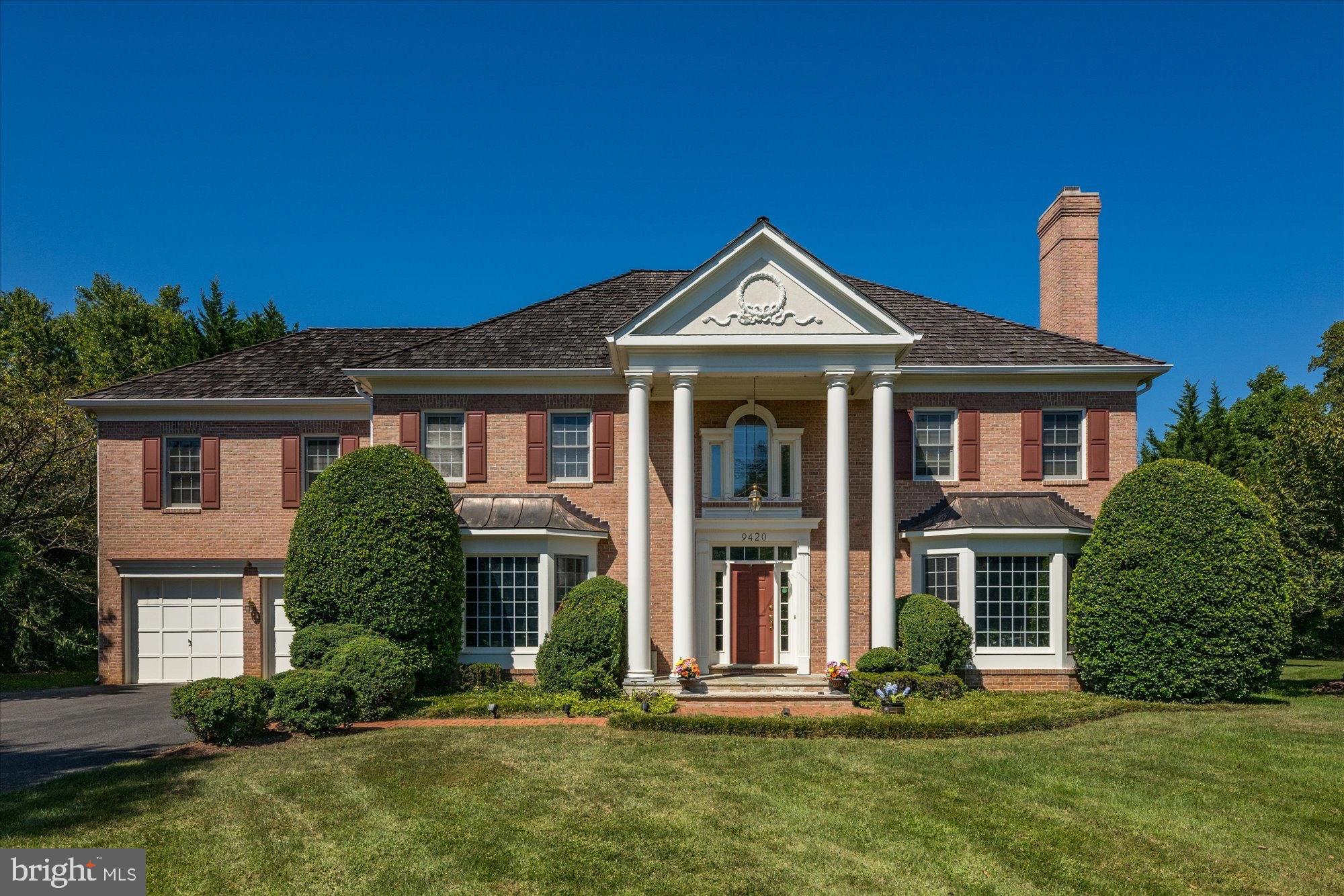 9420 Crimson Leaf Terrace Potomac, MD 20854 - Photo 2 of 33 a front view of a house with a yard