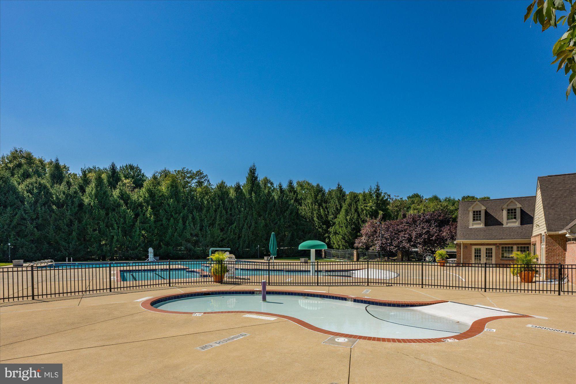 9420 Crimson Leaf Terrace Potomac, MD 20854 - Photo 30 of 33 a view of a swimming pool with lounge chairs