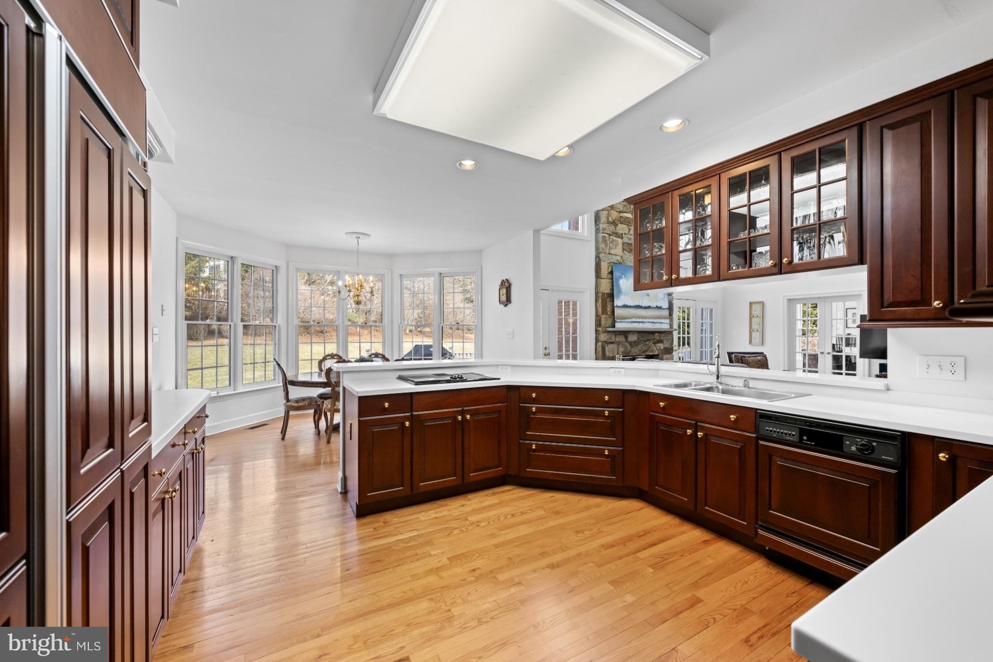 9420 Crimson Leaf Terrace Potomac, MD 20854 - Photo 7 of 33 a large kitchen with stainless steel appliances granite countertop a sink and wooden cabinets