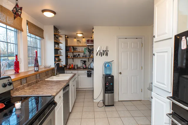 a kitchen with refrigerator and cabinets