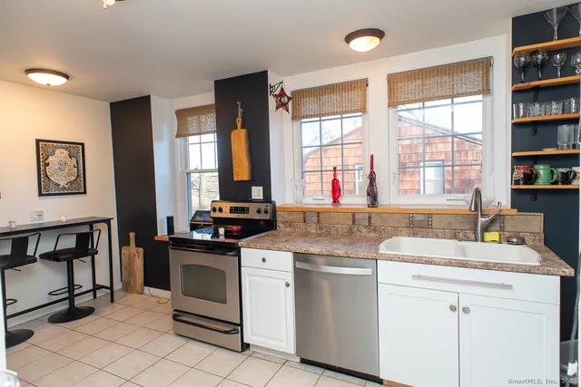 a kitchen that has a sink and a stove in it