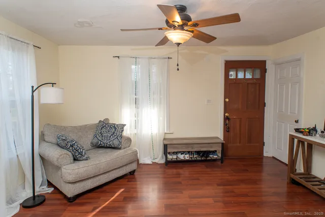 a living room with furniture and a wooden floor