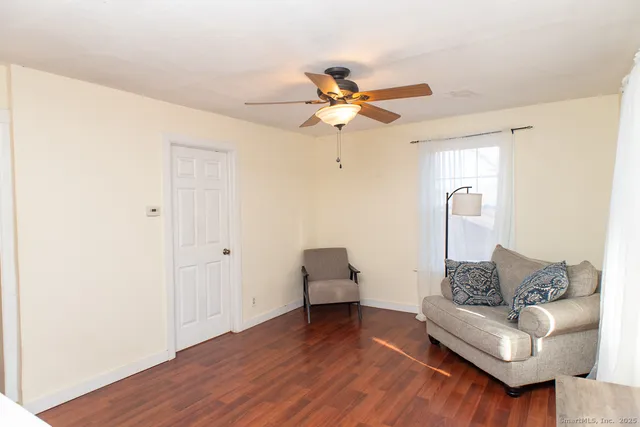 a living room with furniture and a wooden floor