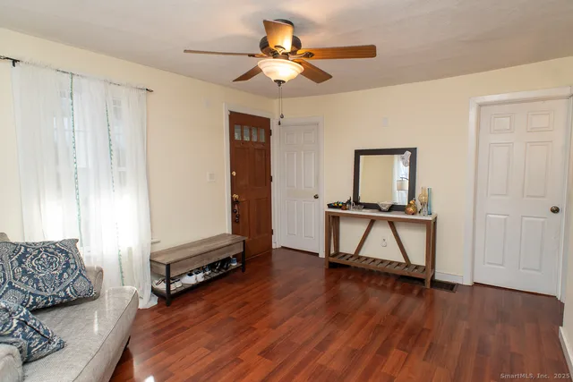 a living room with furniture and a wooden floor