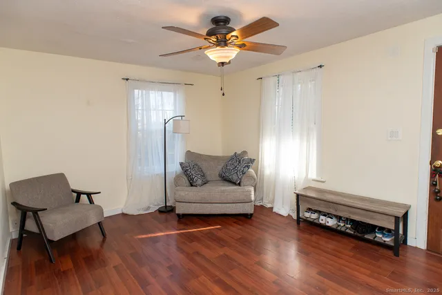 a living room with furniture and a wooden floor