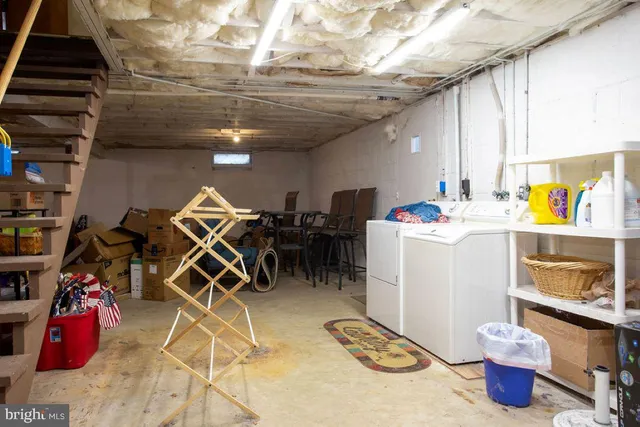 a storage room with washer dryer and bicycles