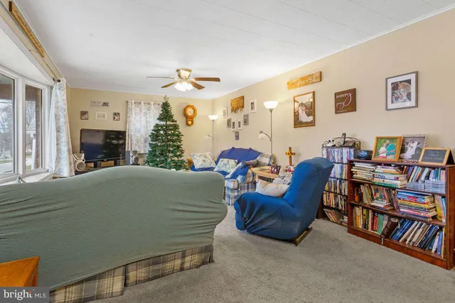 a living room with furniture and a book shelf