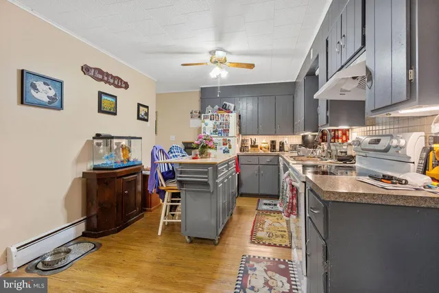 a kitchen with a sink appliances and cabinets