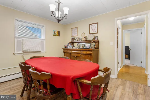 a view of a dining room with furniture and chandelier