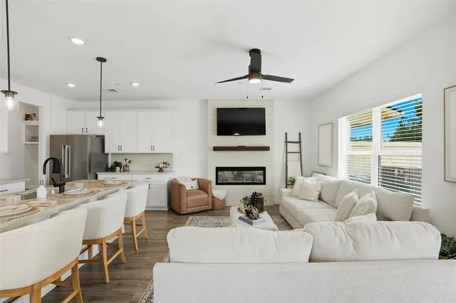 a living room with furniture a fireplace and a flat screen tv