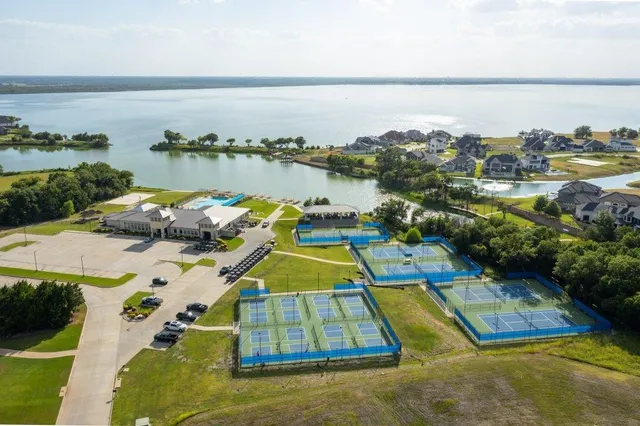 an aerial view of a resort with swimming pool and outdoor seating